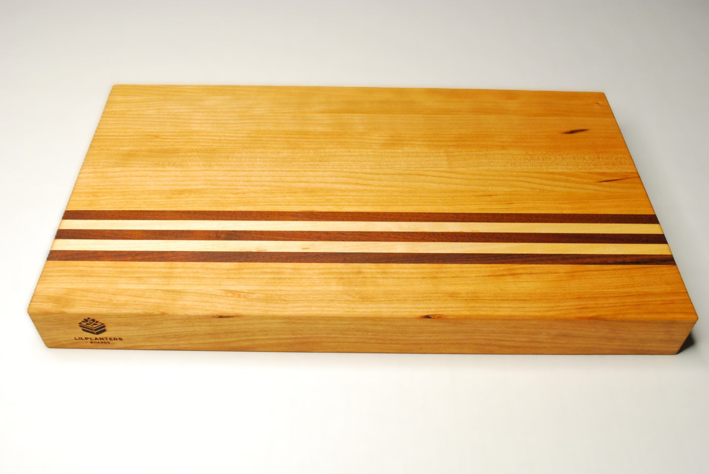 Wooden cutting board with striped design on a white background