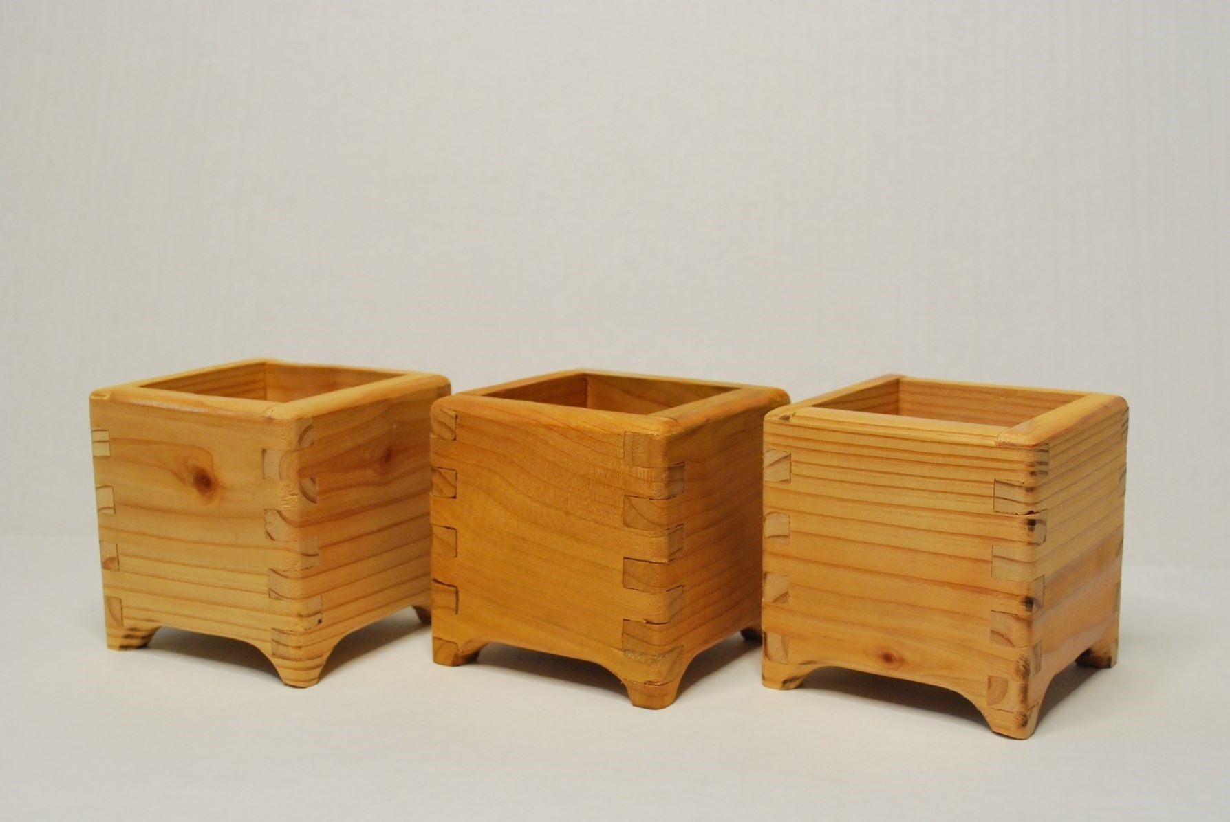 Handmade cubic cedar planter boxes – rustic wooden indoor/outdoor plant containers with finger joints, drainage holes, and eco-friendly natural finish. Perfect for herbs, succulents, or decorative storage.