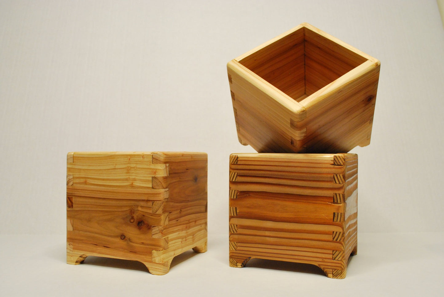 Handmade cubic cedar planter boxes – rustic wooden indoor/outdoor plant containers with finger joints, drainage holes, and eco-friendly natural finish. Perfect for herbs, succulents, or decorative storage.