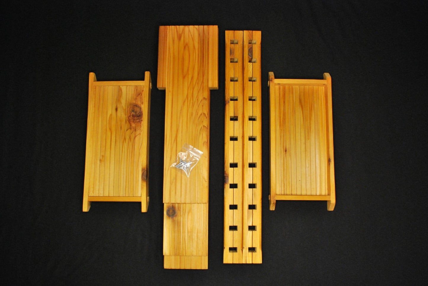 Handmade cedar plant shelf disassembled – individual wood pieces shown with included package contents