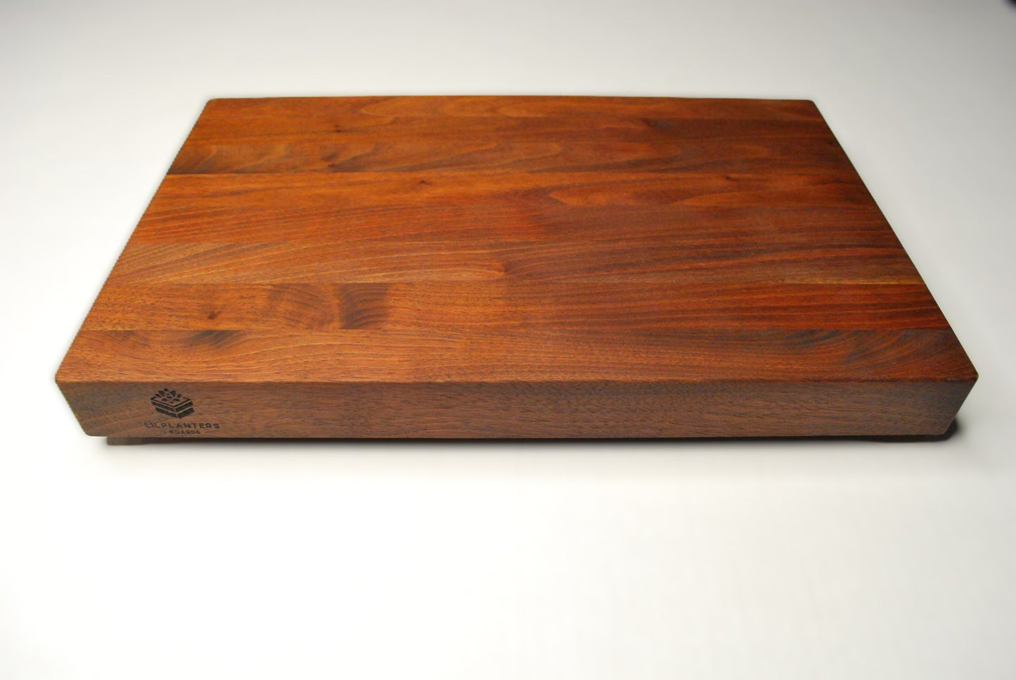 Solid walnut cutting board on a white background