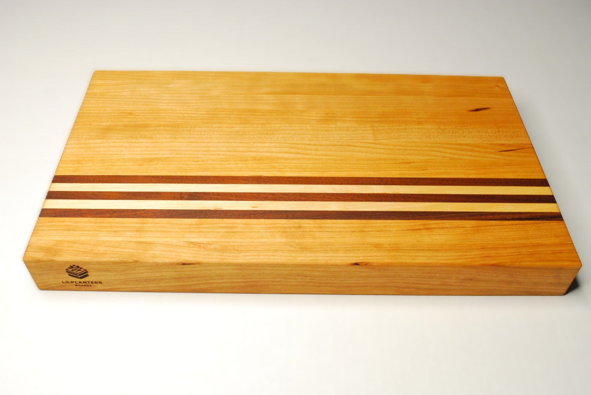 Wooden cutting board with striped design on a white background