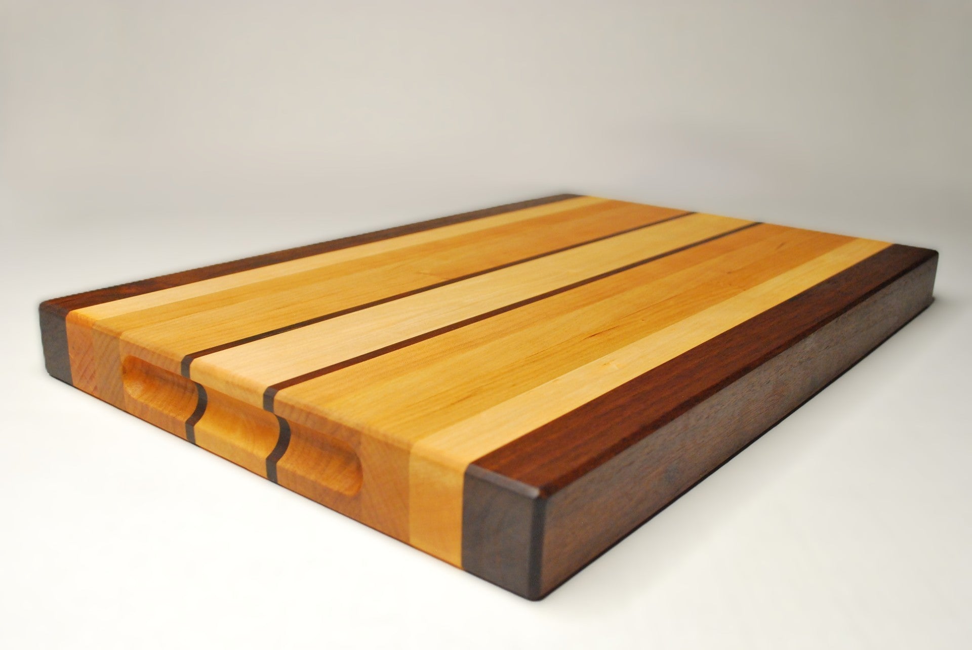 Wooden cutting board with a striped pattern on a white background