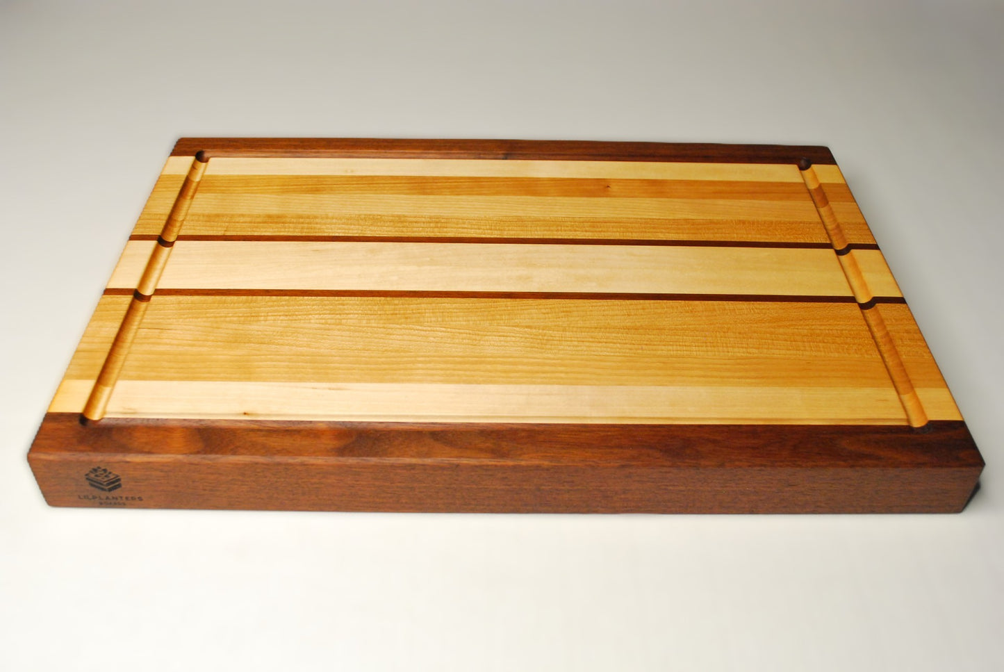 Wooden cutting board with a visible brand logo on a white background