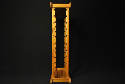 Side profile of tall handmade multi-level cedar plant stand – vertical structure with notched supports and top/bottom caps, set against black background