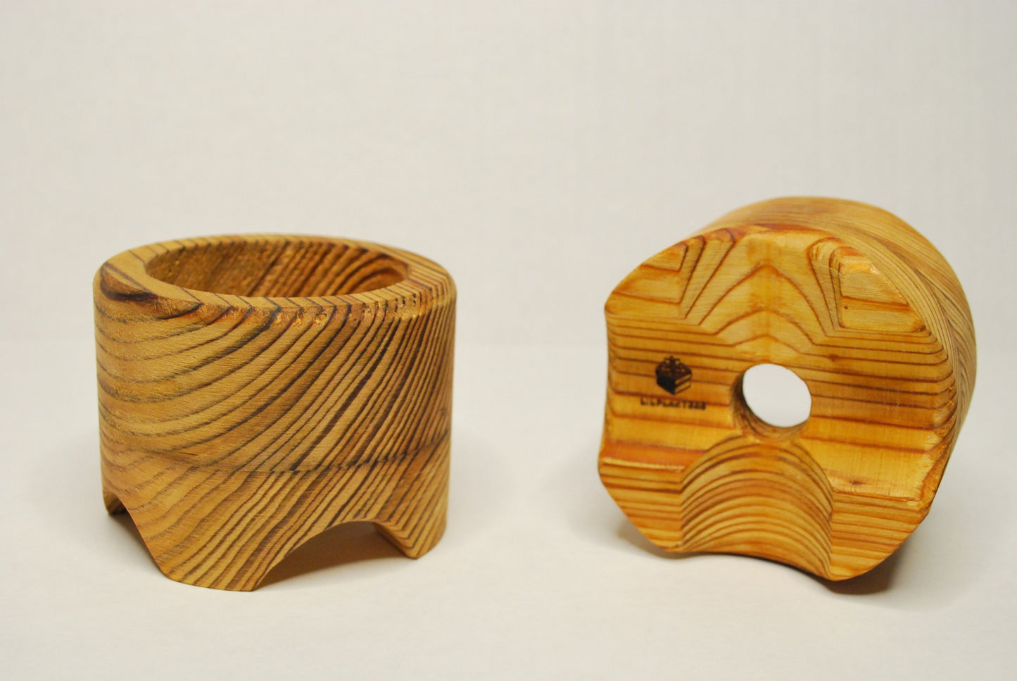 Two circular lilplanters on a white background